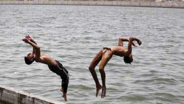 Boys jump into the waters of the Sabarmati river in Ahmedabad as the temperature soared to 43 degrees on Sunday.