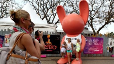 Portia Falk, 4, Chloe Maher, 11, and Anoushka Falk, 7, pose with one of the bunnies as Brian and Tanja Falk take their photo at the Cultural Forecourt at South Bank.