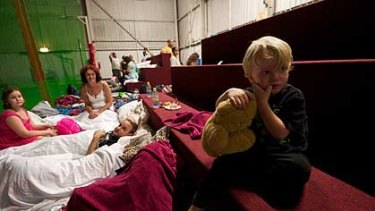 Two-year-old Damien Vieritz has a very unusual sleepover at the evacuation centre at the Ipswich Showgrounds.
