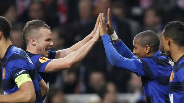 Manchester United's Ashley Young (right) celebrates scoring a goal with teammate Tom Cleverley during the Europa League match between Ajax Amsterdam and Manchester United at the Amsterdam Arena.