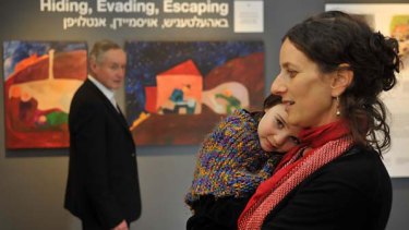 Andrea Kranz with her four-year-old daughter Iliya and her father Hendryk in front of two of her paintings on desplay at the Holocaust Museum, Elsternwick. <i>Picture: Michael Clayton-Jones</i>
