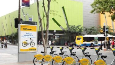 A CityCycle station. The bicycles and vertical advertising space carry ads.