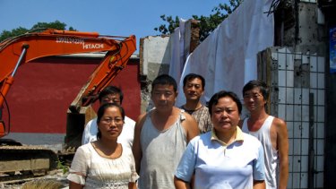 Yu Pingju (right), her brothers and sisters in-law stand defiantly in front of the family's Beijing residence before it was demolished.