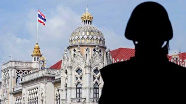 A Thai soldier stands guard at Government House in Bangkok.