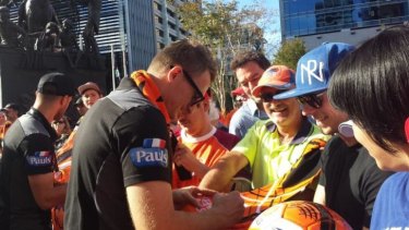 Besart Berisha signs autographs for fans after a city tickertape parade on Tuesday.