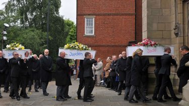 Tragedy: Coffins bearing the bodies of six children who died in a house fire are carried into St Mary's Church in Derby.