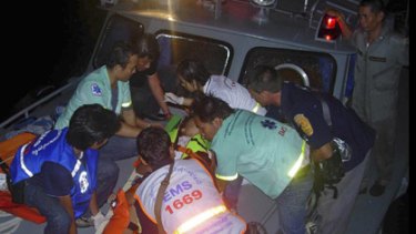 Rescue workers carry an injured victim to a hospital.