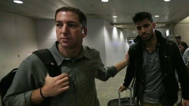 US journalist Glenn Greenwald (left) walks with his partner David Miranda in Rio de Janeiro's International Airport.