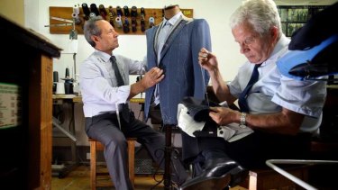 Master tailor Tino Di Mattia (left) and Pasquale Strangis perform their craft at American Tailors in Bourke Street.