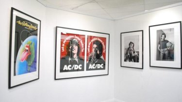 The Rolling Stones and AC/DC are among the posters on display.