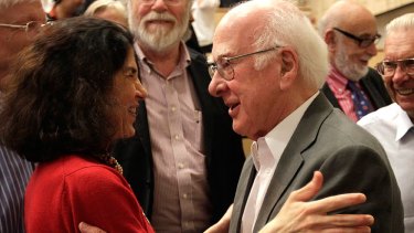 British physicist Peter Higgs congratulates the experiment team after last night's announcment.