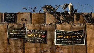 Banners naming the Iraq soldiers that have died in combat line a wall at Camp Taji.