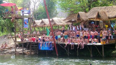 Dangerous pursuit ... Crowds of tourists wait to go tubing in Vang Vieng.
