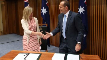 Prime Minister Tony Abbott signs a environmental planning MOU with ACT Chief Minister Katy Gallagher.