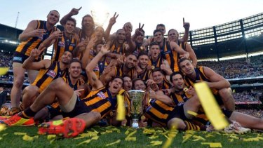 The Hawks celebrate with the premiership cup.
