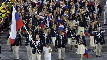 Sergei Tetiukhin carries the flag of Russia during the opening ceremony for the 2016 Summer Olympics in Rio de Janeiro, Brazil, Friday, Aug. 5, 2016. (AP Photo/Matt Slocum)