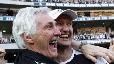Mick Malthouse embraces fitness coach David Buttifant after the win.