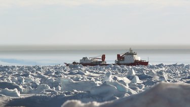 The Chinese icebreaker Xue Long remains stuck in sea ice in Watt Bay, Antarctica, near the beset vessel Akademik Shokalskiy.