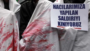 Syrian protesters in Turkey call for action against Bashar al-Assad, some dressed in shrouds stained with mock blood.