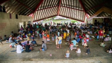 People gather at the Panatina Pavilion evacuation centre in Honiara.