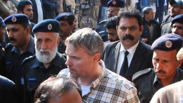 Two slain in the street ... Raymond Davis is escorted from a court in Lahore last month.