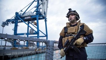 A guard on the Norwegian frigate Helge Ingstad as it leaves the port of Limassol in Cyprus, part of the Danish-Norwegian force that will transport Syria's chemical agents out of the country to destruction. 