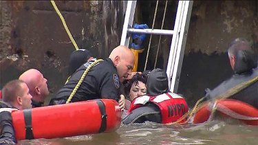 Divers rescue one of the injured passengers after the helicopter crash.
