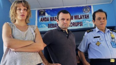 French journalists Thomas Dandois, centre, and Valentine Bourrat with an Indonesian immigration official in Jayapura city.
