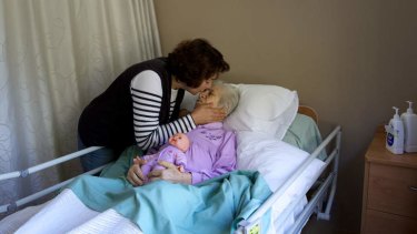 Helping hands: Khana Dawod in a nursing home, believes the doll is a real baby.