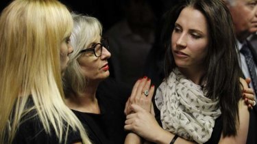 Oscar Pistorius's sister Aimee, right, is consoled by relatives.