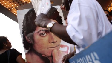 A poster of Michael Jackson is displayed outside Harlem's Apollo theatre.