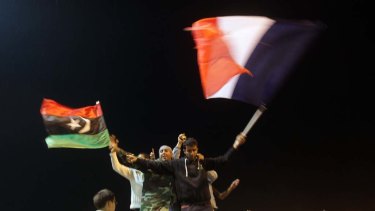 Benghazi ... rebels wave the French flag and their Kingdom of Libya flag after the UN Security Council's resolution for a no-fly zone.