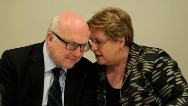 Labor Senator Trish Crossin speaks with Liberal George Brandis at the hearings into the proposed changes to the anti-discrimination laws.