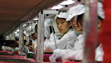 Workers are seen inside a Foxconn factory in the township of Longhua in the southern Guangdong province.