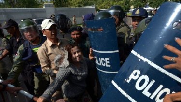 A Cambodian rights activist clashes with police at a protest outside the Australian embassy in Phnom Penh.