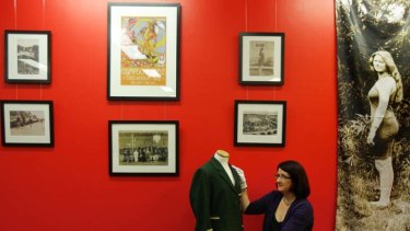 Water life ... Georgina Keep with an Olympic blazer and other items from the Mina Wylie exhibition at the Bowen Library, Maroubra.