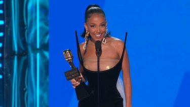 Doja Cat accepts the top R&B artist award on stage during the 2022 Billboard Music Awards.