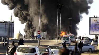 Emergency services arrive at the scene of a fuel-tanker explosion in Tripoli yesterday as residents flee.
