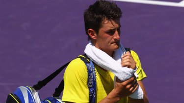 Frustrated  ... Tomic leaves the court after his defeat.