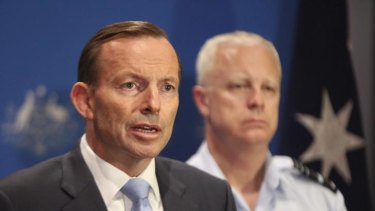 Tony Abbott speaks of Australia's military plans with the Chief of Defence, Air Chief Marshal Mark Binskin, in Darwin on Sunday.