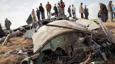 Malfunction ... Libyans inspect the wreckage of the US fighter jet.