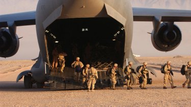 Members of the Australian Special Operations Task Group disembark a United States Air Force C-17 Globemaster at a base in Afghanistan.
