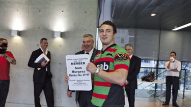 Ready to 'knuckle down' . . . forward Sam Burgess tries on his new colours and confirms his South Sydney membership to the media after arriving from England yesterday.