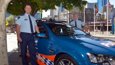 A fine machine: Assistant Commissioner Robert Hill and Superintendent Dean McWhirter with the number plate recognition car.