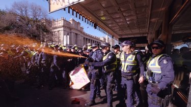 Police use pepper spray at the protest in Melbourne.