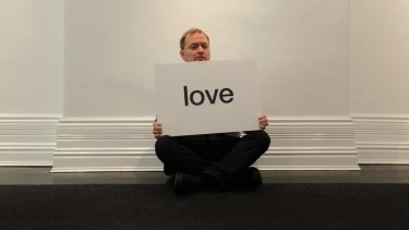 For love and money: Charles Firth with the word he has donated for a satirical exhibition in Potts Point.
