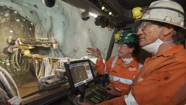 Olympic Dam asset president Jacqui McGill (at rear)  inside the cab of a Jumbo driller about 440m underground at BHP Billiton's Olympic Dam mine,  570km north of Adelaide. The drill operator is Tony Richter.