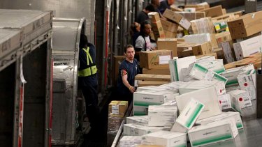 FedEx employees sort through packages at a shipping center that are heading out for delivery on Cyber Monday.