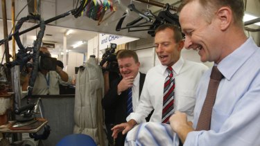 Member for Dunkley Bruce Billson and opposition leader Tony Abbott during a visit to the Bells Foxy Dry Cleaners in Queanbeyan owned by Jason Webb, right.