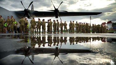 Heading home: The last 50 Australian infantry personnel line up to leave Dili on Friday.